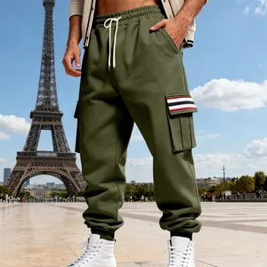 Detail view of men's olive green cargo joggers with striped pocket and cuffed ankles