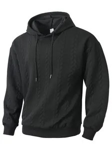 Detailed macro view showing the premium cable knit jacquard texture of a black hoodie