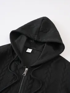 Close-up of black men's zip-up hooded jacket showing jacquard texture and material tag
