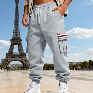 Detail view of grey fleece cargo pants with striped pocket flaps and drawstring waist