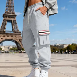 Close-up detail view of grey fleece cargo sweatpants with striped side pocket flap