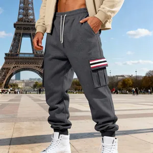 Detail view of men's grey fleece cargo sweatpants with stylish striped pockets.