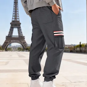 Detail of grey men's cargo sweatpants featuring a striped side pocket and fleece