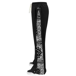 Detail of men's black hip-hop straight pants with paisley panels and snap buttons