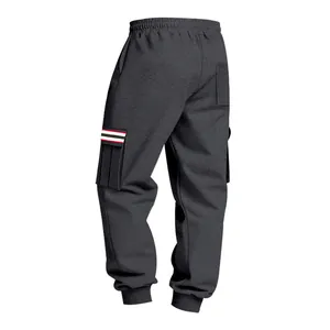 Detailed view of men's charcoal grey fleece cargo joggers with striped pocket accents.