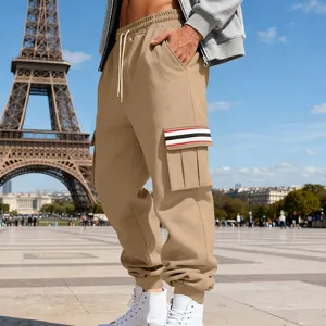Detailed view of men's khaki cargo joggers with striped pocket detail and elastic cuffs