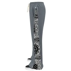 Detailed view of men's gray hip-hop pants with paisley side panels and snap buttons.