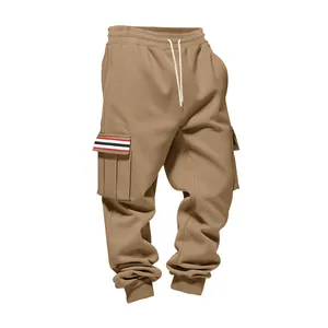 Close-up view of khaki cargo pants featuring a striped pocket flap and drawstring waist.