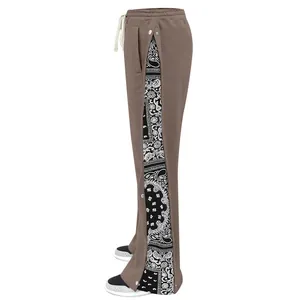 Detailed side view of men's casual pants with paisley print and snap buttons.