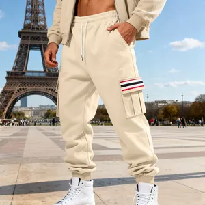 Detail of beige men's cargo sweatpants with striped pocket on a lifestyle background