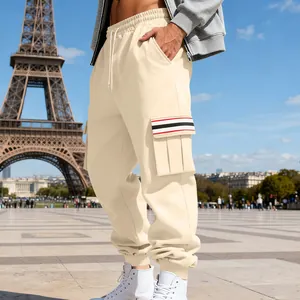 Men's cream fleece cargo pants with striped pocket detail in a Paris street setting