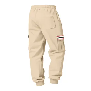 Detail view of beige mens fleece cargo pants with red and black striped pocket flap