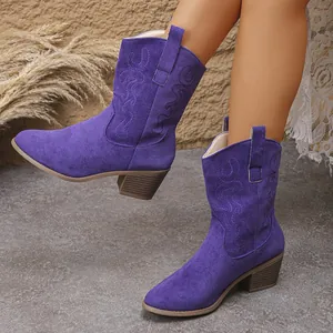 Detailed view of purple suede western boots with intricate embroidery and chunky heel