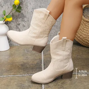 Detailed view of beige suede western cowboy boots with embroidery and 6cm heel.