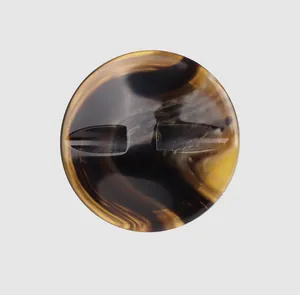 Macro detail of a premium resin button with an amber and brown tortoiseshell pattern.
