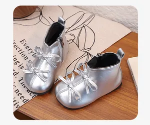 Detailed view of silver metallic baby girl boots featuring elegant double bow accents.