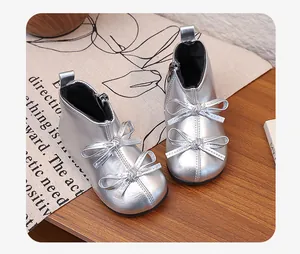Close-up of silver girls' ankle boots featuring double bow knots and side zipper