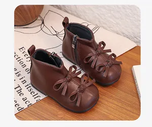 Stylish brown leatherette toddler boots featuring double bow design and side zipper detail