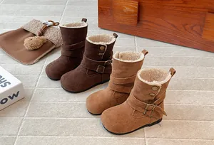 Detail of retro Maillard style girls' winter boots with cozy fleece lining and buckles.