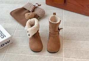 Detail view of foldable girls' suede boots with warm cream fleece lining and straps.
