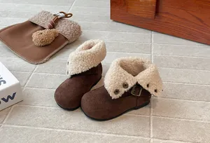 Close-up of brown girls' velvet Martin boots with foldable cream fleece collar