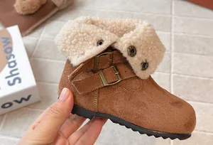 Macro view of stylish brown winter boots for girls with warm faux shearling lining