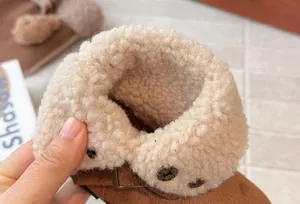 Detailed view of warm faux fur lining on a brown vintage girls' winter boot
