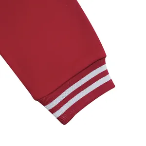Close-up detail showing the high-quality striped ribbed cuff of a red fleece baseball jacket
