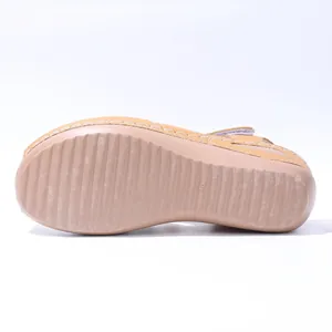 Close-up of anti-slip sole on beige wedge platform sandal showing size 38