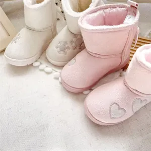 Detailed view of warm girls' winter snow boots with heart and snowflake embroidery