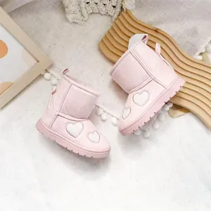 Close-up of pink toddler snow boots featuring heart embroidery and soft velvet lining.