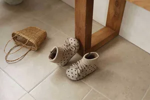 High-angle view of retro beige polka dot boots for toddler girls with knit collars
