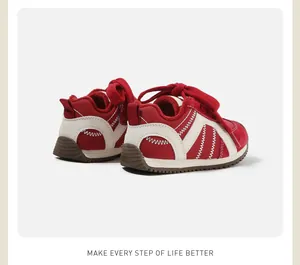 Detailed view of red and cream infant winter fleece walking shoes with soft soles