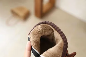 Detailed macro view showing the soft brown fleece lining of girls winter ankle boots