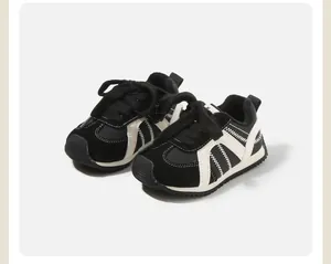 Side detail of black and white infant winter walker shoes with soft fleece lining