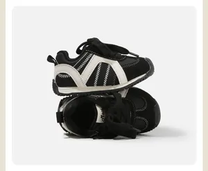 Close-up of black and white baby toddler sneakers stacked on a clean light background