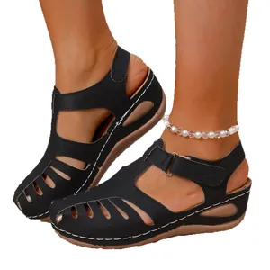 Women's black wedge sandals with closed-toe design and contrast stitching details.