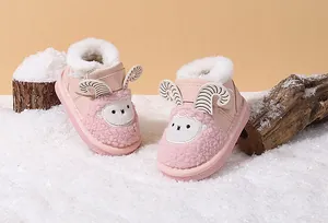 Detail view of pink baby snow boots featuring a cute sheep face and warm faux fur.