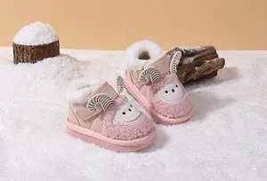 Detailed view of pink baby winter boots with cute sheep cartoon and warm faux fur lining