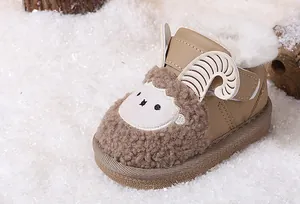 Detailed side view of the cute cartoon sheep baby snow boot featuring soft fleece lining