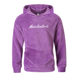 Macro detail of a purple plush fleece hoodie with white cursive Muscleattack embroidery