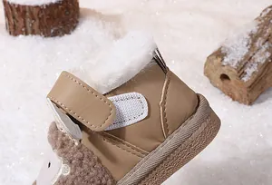 Macro view of toddler winter snow boot featuring warm white fleece lining and strap