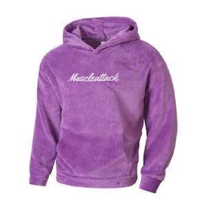 Close-up of a purple fleece hoodie featuring white Muscleattack chest embroidery.