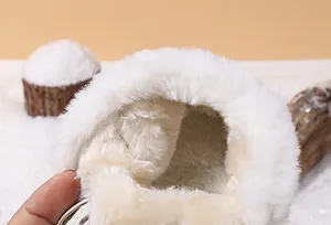 Detailed close-up of the thick warm white fleece lining of baby winter snow boots.