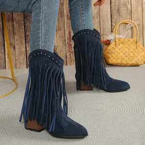Detailed view of navy blue suede western boots with long fringe and gold studs.