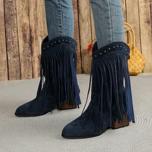 Detail shot of navy blue fringe cowboy boots with gold studs and chunky wooden heel
