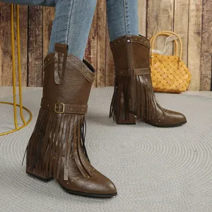 Close-up of brown mid-calf cowboy boots with fringes and rivet details