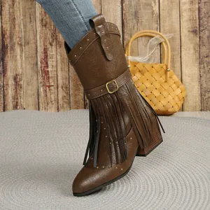 Detailed view of brown western mid-calf boots featuring fringe, rivets and buckle