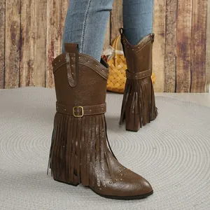 Detailed view of brown Western cowboy boots featuring fringe details and golden rivets