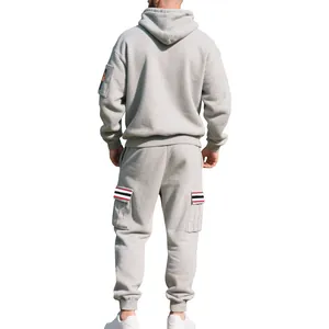 Back view of a men's heavy fleece grey hoodie and cargo sweatpants set with striped details